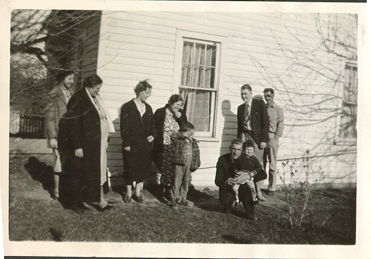 Elsie (William's wife), her mother, Lena Tollas, Jenny Barker, Forest Barker, Alfred Tollas, and kneeling, William Barker, I think the children are those of William & Elsie. This is a side view of our Hadleigh Hill Farm cottage.